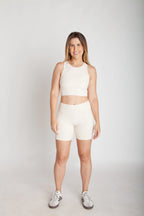 Bermuda fitness feminina off white com bolsos laterais em Nagoya vista frontal corpo inteiro